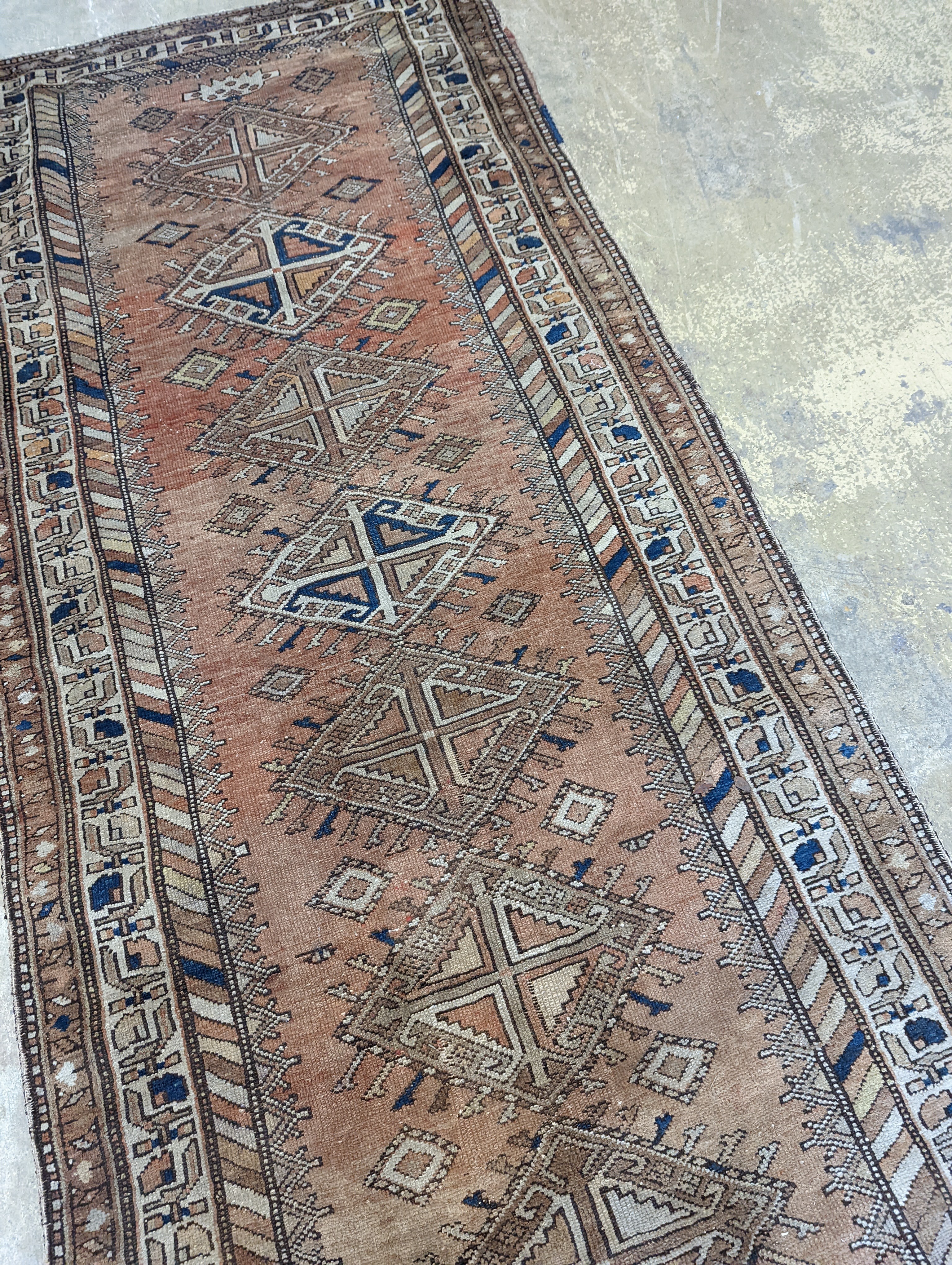 An antique Caucasian red ground runner, 372 x 106cm